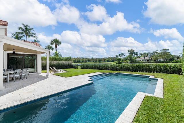 view of pool featuring a yard and a patio area