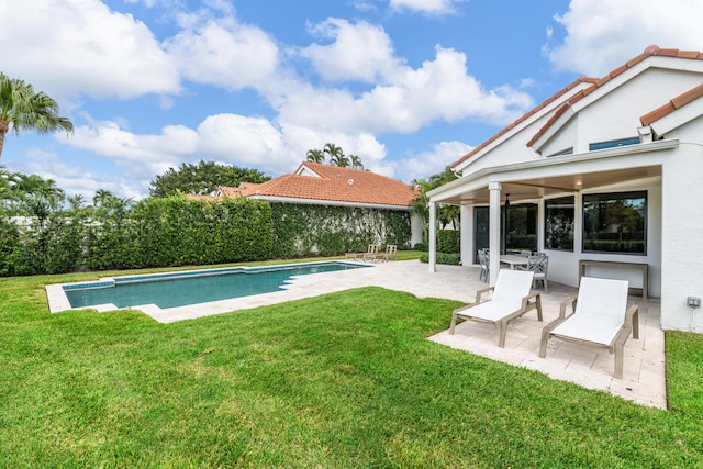 view of swimming pool with a patio area and a lawn