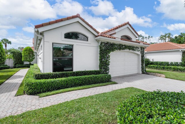 mediterranean / spanish-style home featuring a front lawn