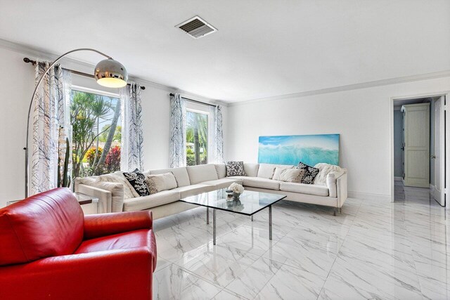 living room featuring tile patterned floors, plenty of natural light, and crown molding