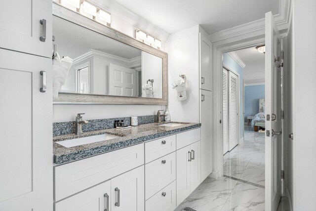 bathroom featuring tile patterned floors, dual bowl vanity, and ornamental molding