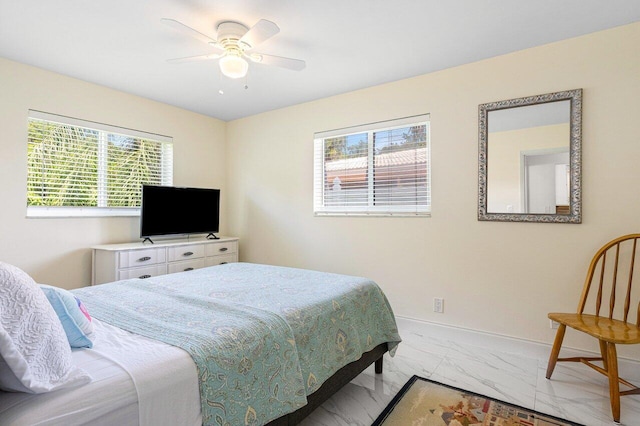 bedroom featuring baseboards, marble finish floor, and a ceiling fan