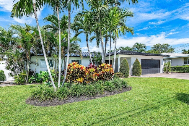 view of front of home with a garage and a front yard