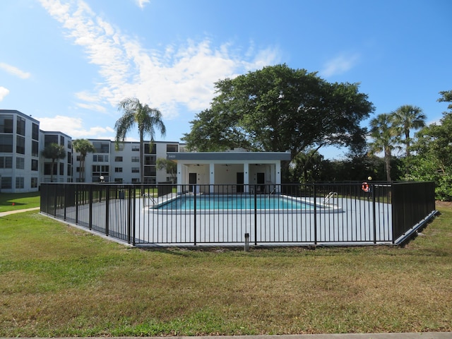 view of swimming pool with a yard and a patio