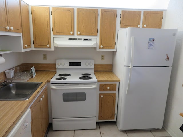 kitchen with sink, white appliances, and light tile patterned floors