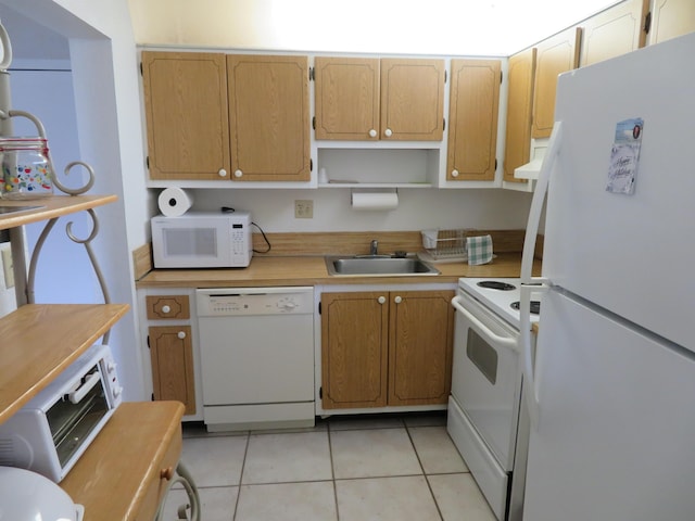 kitchen with white appliances, sink, and light tile patterned floors