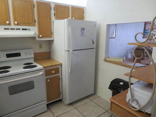 kitchen with white appliances and light tile patterned floors