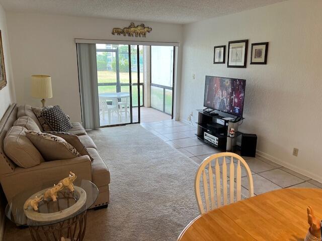 tiled living room with a textured ceiling