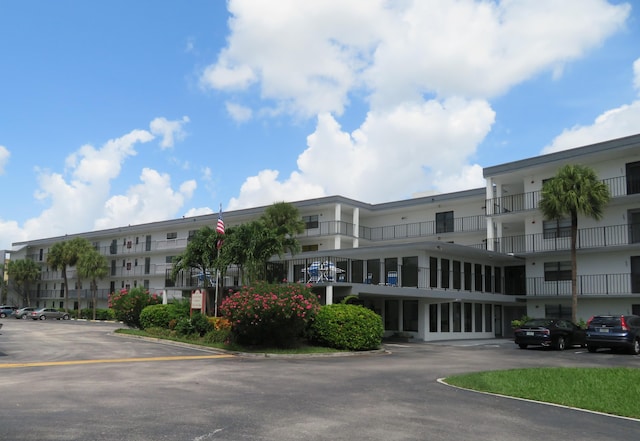 view of property featuring uncovered parking