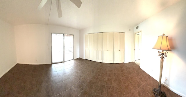 unfurnished bedroom with ceiling fan and lofted ceiling