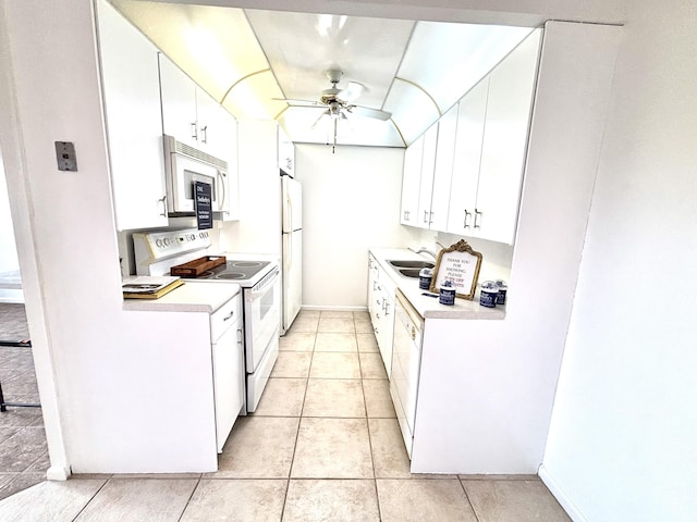 kitchen featuring ceiling fan, sink, light tile patterned floors, white appliances, and white cabinets