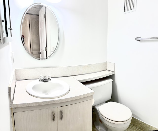 bathroom with tile patterned floors, vanity, and toilet