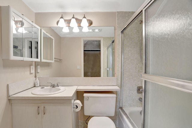 full bathroom with vanity, toilet, and bath / shower combo with glass door