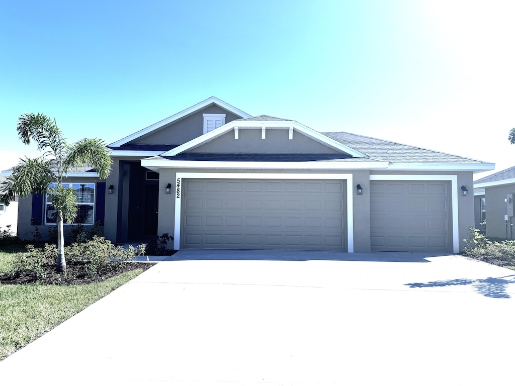 5482 Lugo St, Fort Pierce, FL 34951 - ranch-style house with a garage, stucco siding, and concrete driveway