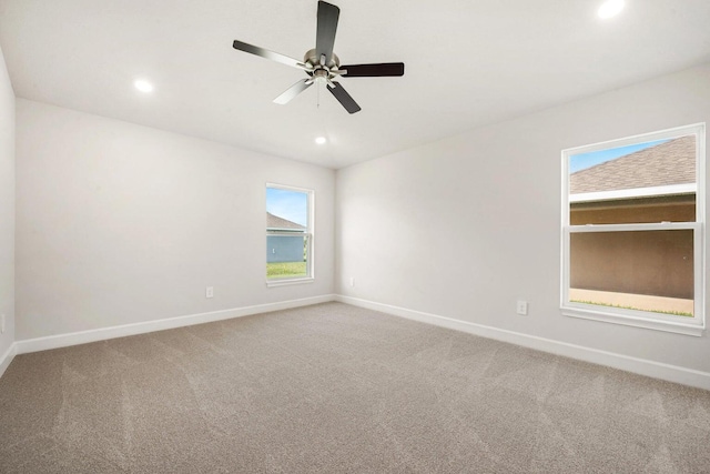 carpeted empty room featuring ceiling fan