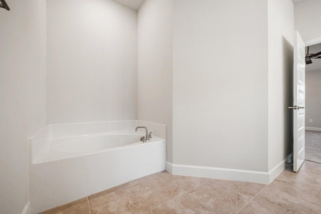 bathroom featuring a tub to relax in, ceiling fan, and tile patterned flooring