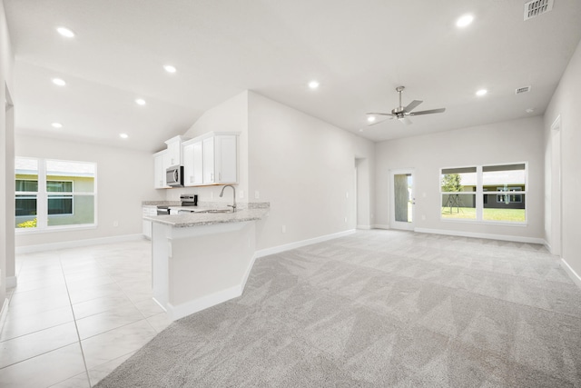 unfurnished living room with light colored carpet, ceiling fan, lofted ceiling, and sink