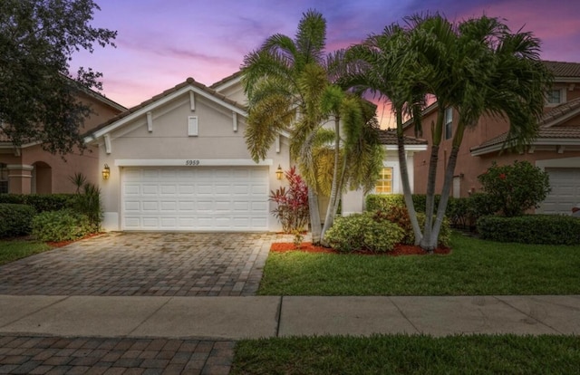 view of front of home featuring a yard and a garage