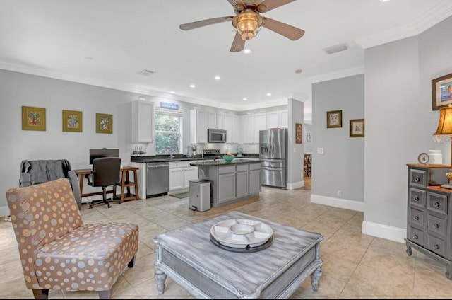 living room with crown molding, ceiling fan, and light tile patterned floors