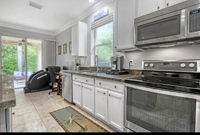 kitchen featuring ceiling fan, white cabinets, sink, appliances with stainless steel finishes, and light tile patterned floors