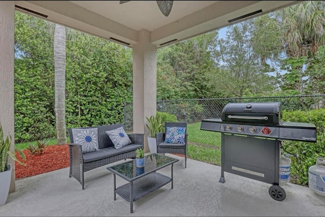 view of patio / terrace featuring ceiling fan, an outdoor living space, and a grill