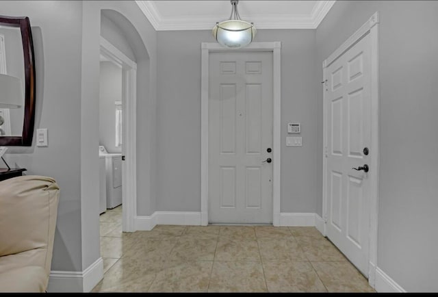 tiled foyer with washer / clothes dryer and crown molding