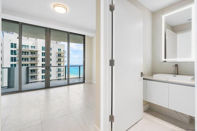 bathroom featuring vanity, tile patterned floors, and french doors