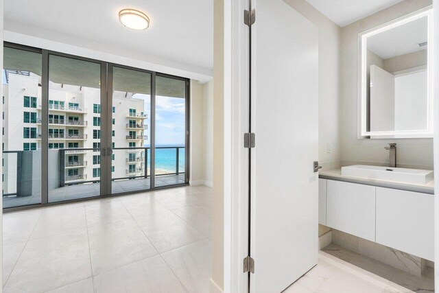 bathroom featuring tile patterned floors, toilet, vanity, and an enclosed shower