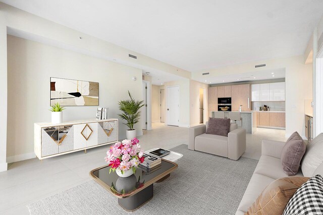 unfurnished living room featuring sink, beverage cooler, floor to ceiling windows, and light tile patterned floors