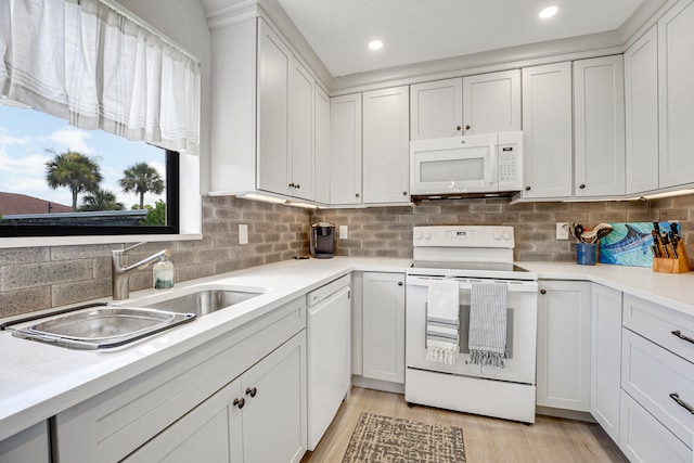 kitchen with white cabinetry, light hardwood / wood-style flooring, range, and decorative backsplash