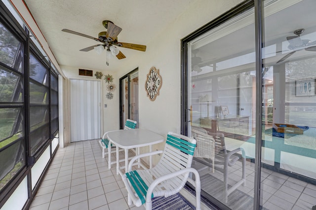 sunroom / solarium featuring ceiling fan