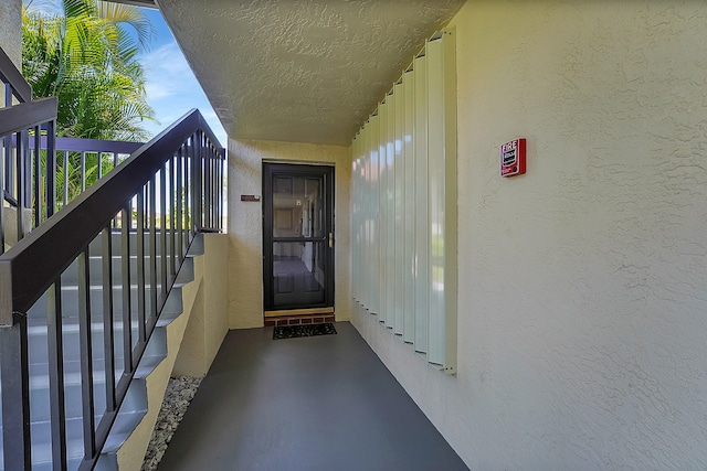 view of exterior entry with a balcony