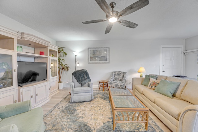 living room featuring light hardwood / wood-style flooring and ceiling fan