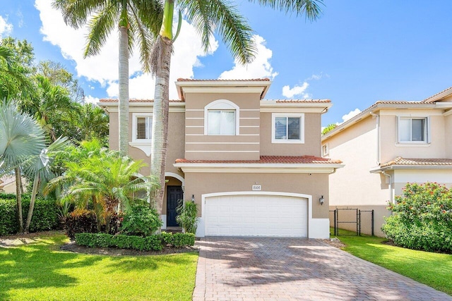 mediterranean / spanish-style home with a garage and a front lawn