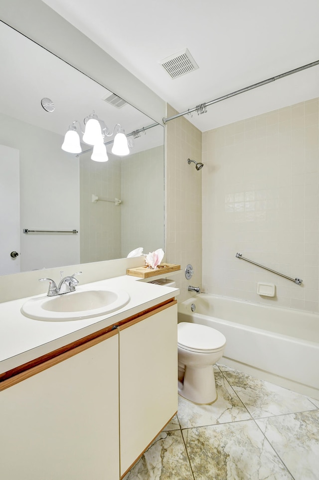 full bathroom with vanity, toilet, and tiled shower / bath