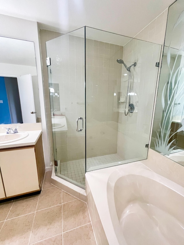 bathroom with tile patterned flooring, vanity, and an enclosed shower