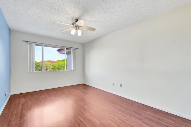 spare room with a textured ceiling, wood-type flooring, and ceiling fan