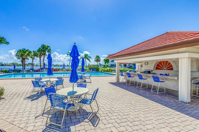 view of patio / terrace featuring a community pool and exterior bar