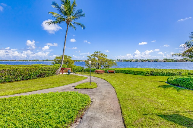 view of community with a water view and a lawn