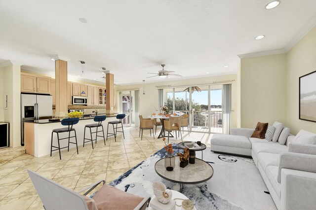 living room with crown molding and ceiling fan