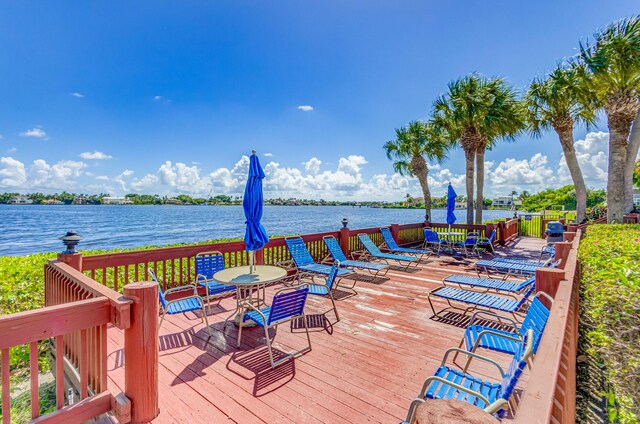 wooden terrace featuring a water view