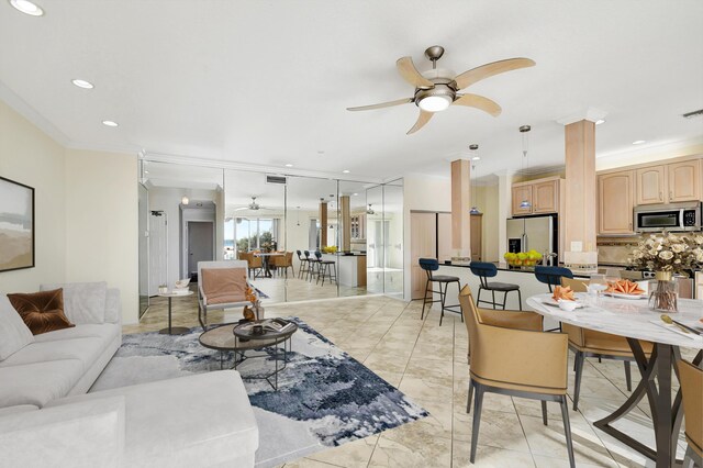 living room featuring crown molding and ceiling fan