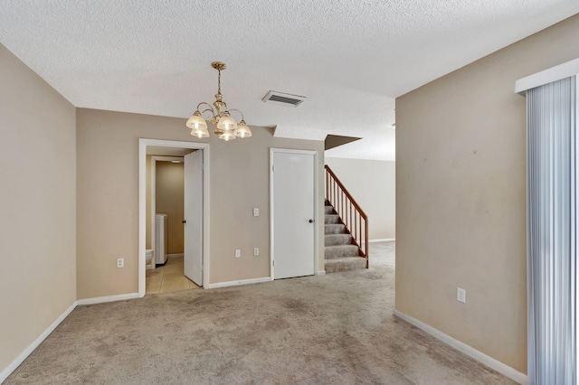 doorway with light carpet and a textured ceiling