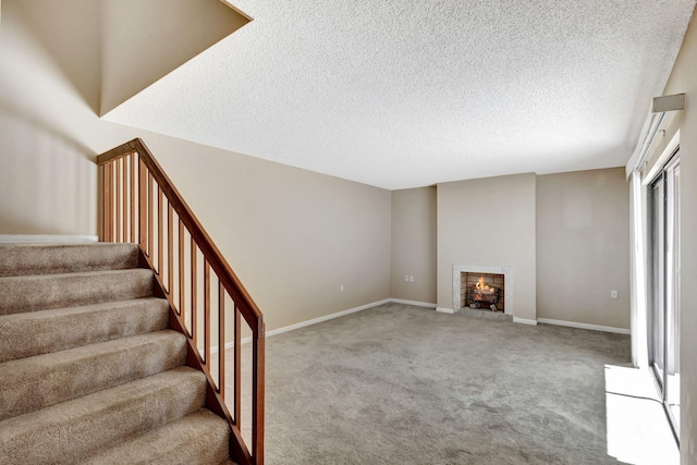 spare room with a textured ceiling and carpet floors