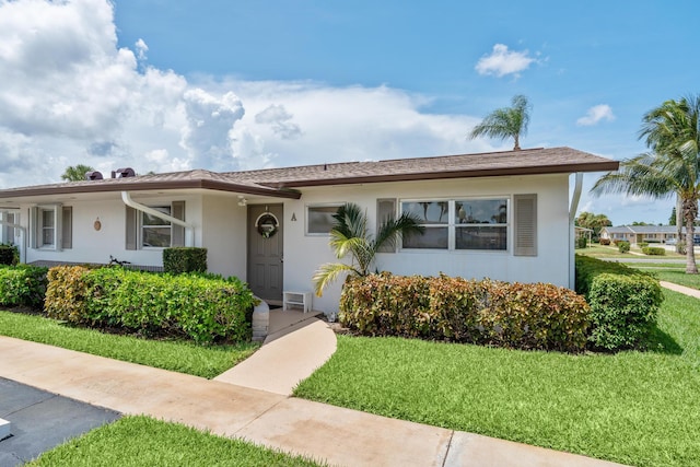 single story home with a front lawn