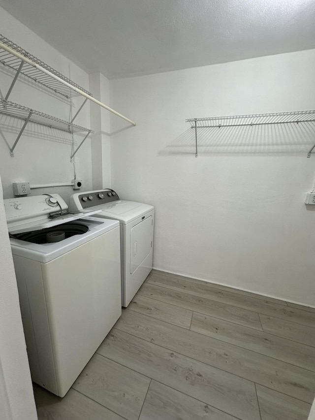 washroom with washer and dryer