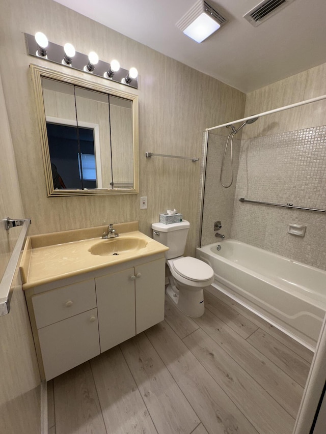 full bathroom featuring vanity, toilet, shower / bath combination, and wood-type flooring