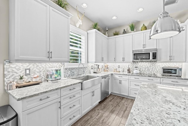 kitchen featuring white cabinets, appliances with stainless steel finishes, and sink