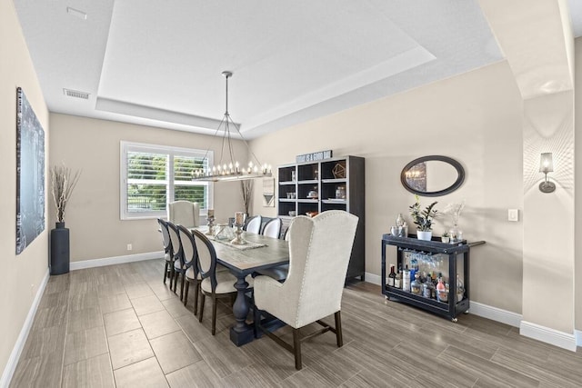 dining space featuring a tray ceiling