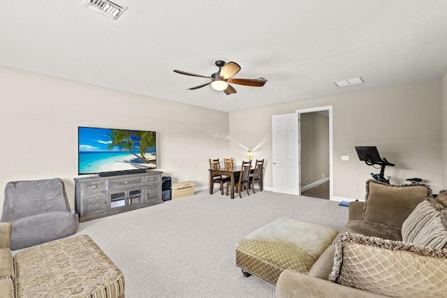 carpeted living room featuring ceiling fan